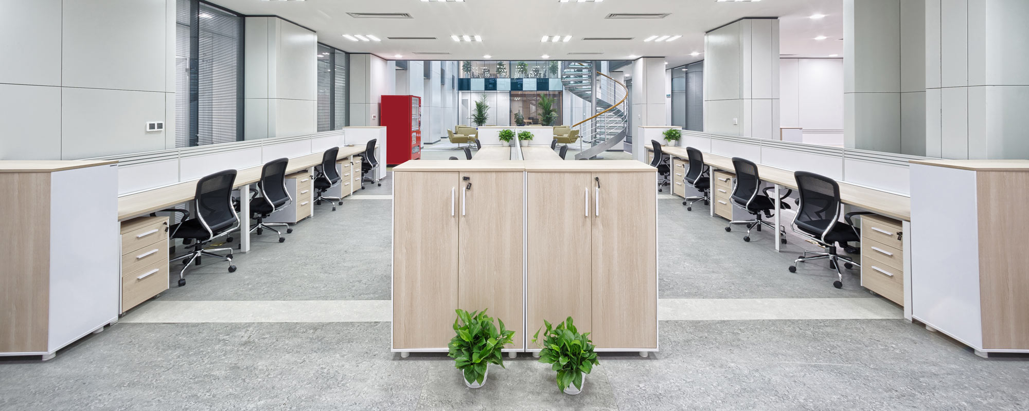 long rows of desks in brightly lit modern commercial office